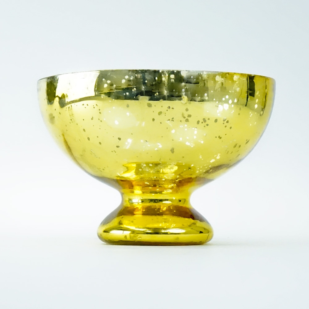 This gold mercury glass pedestal compote bowl vase is made of heavy thick glass in the sparkling gold finish.